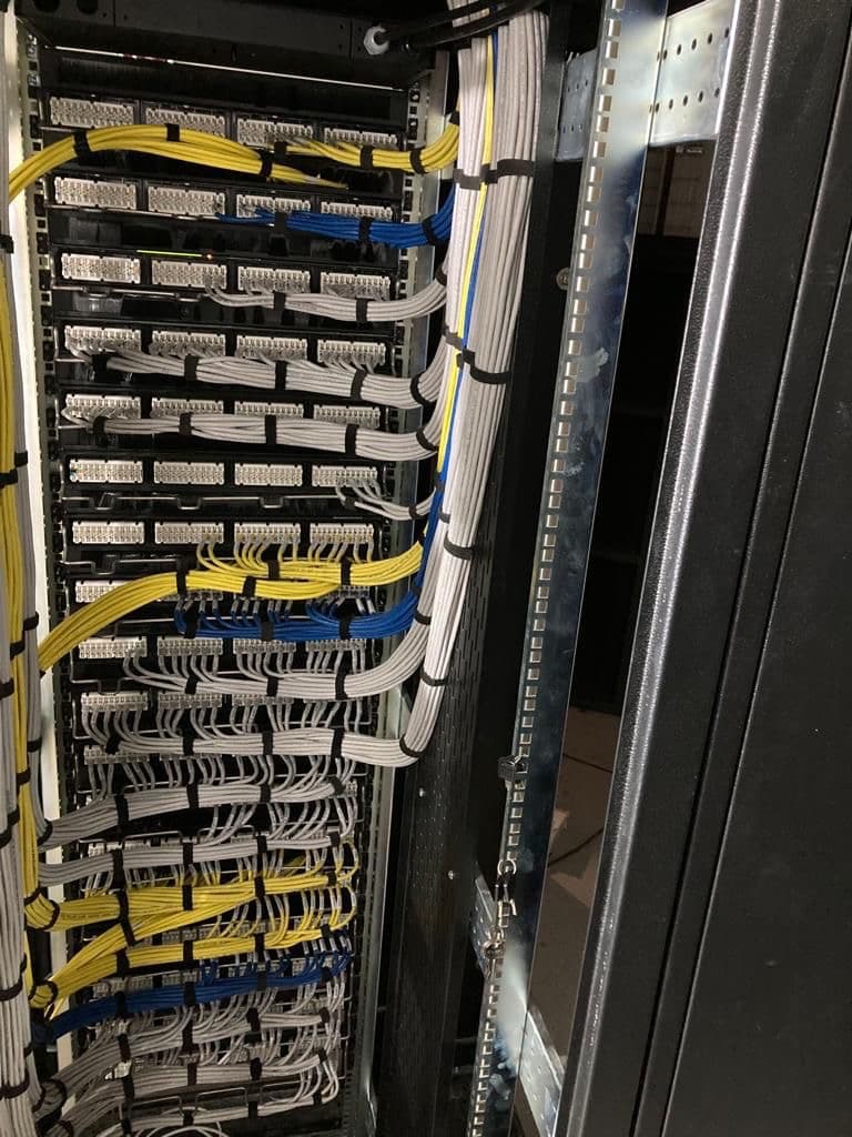Cleanly dressed structured network cabling and patch panels installed in-house by a licensed electrical contractor